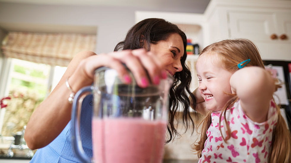 Family health and fitness mother and daughter making smoothie